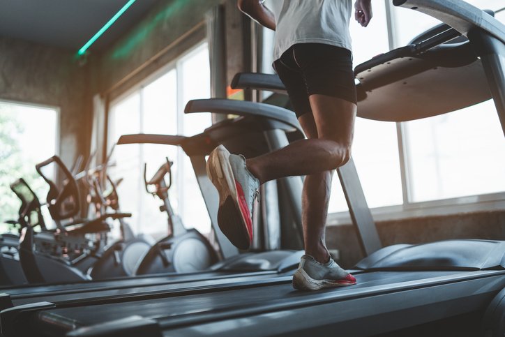 Close up of feet, sportman runner running on treadmill in fitness club. Cardio workout. Healthy lifestyle, guy training in gym. Sport running concept iStock
