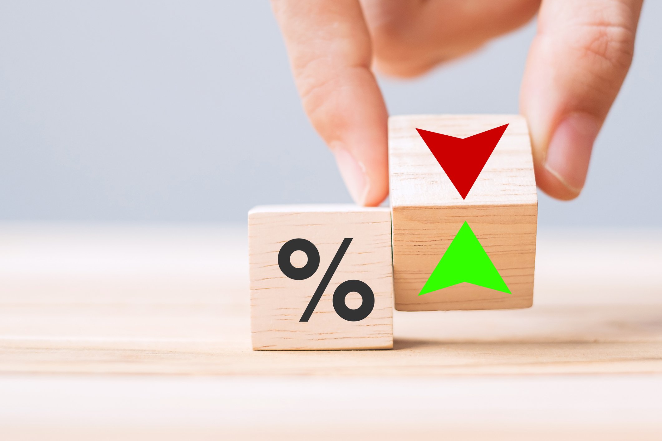 business man Hand change wood cube block with percentage to UP and Down arrow symbol icon. Interest rate, stocks, financial, ranking, mortgage rates and Cut loss concept business man Hand change wood cube block with percentage to UP and Down arrow symbol icon. Interest rate, stocks, financial, ranking, mortgage rates and Cut loss concept