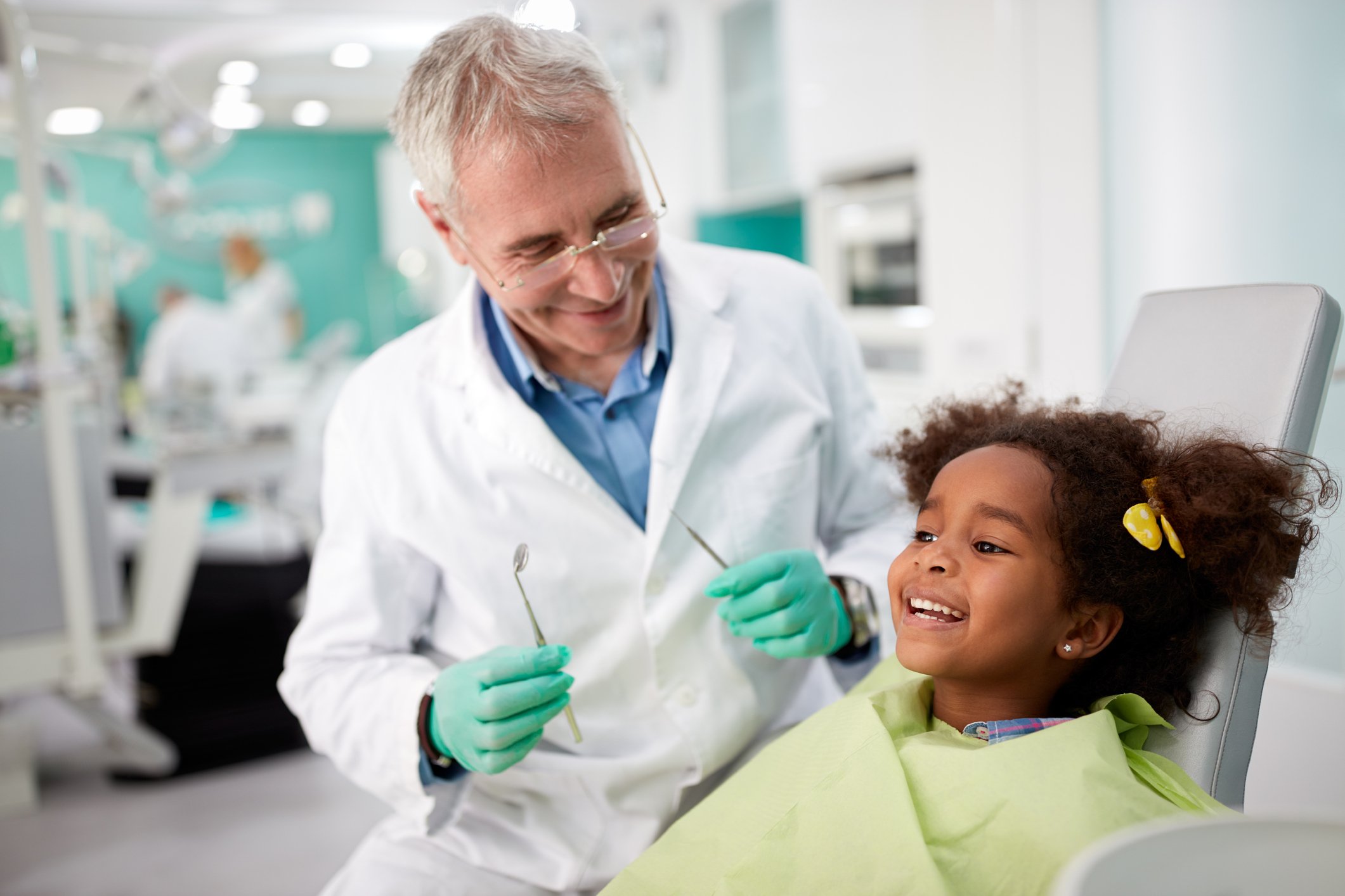Happy kid after repairing tooth Happy kid on dental chair after repairing tooth